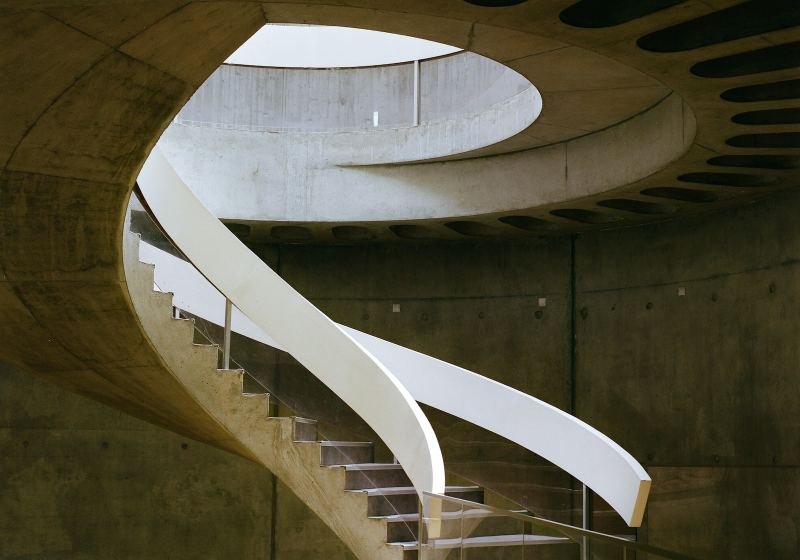 Sweeping modern staircase in a concrete atrium